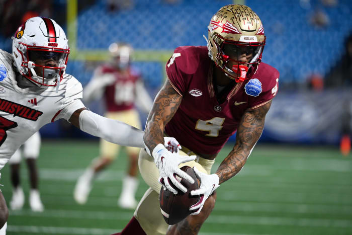 Dec 2, 2023; Charlotte, NC, USA; Florida State Seminoles wide receiver Keon Coleman (4) makes a catch against the Louisville Cardinals in the second quarter at Bank of America Stadium.